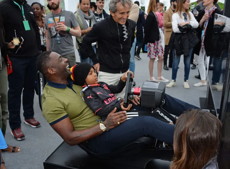 Idris Elba conduce un simulador con su hijo Winston el 28 de abril de 2018 en París. | Foto: Getty Images