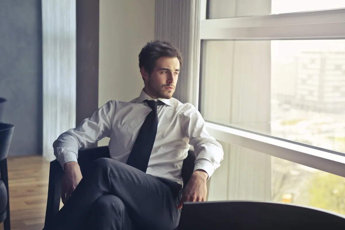 A man looks outside the window. | Photo: Pexels