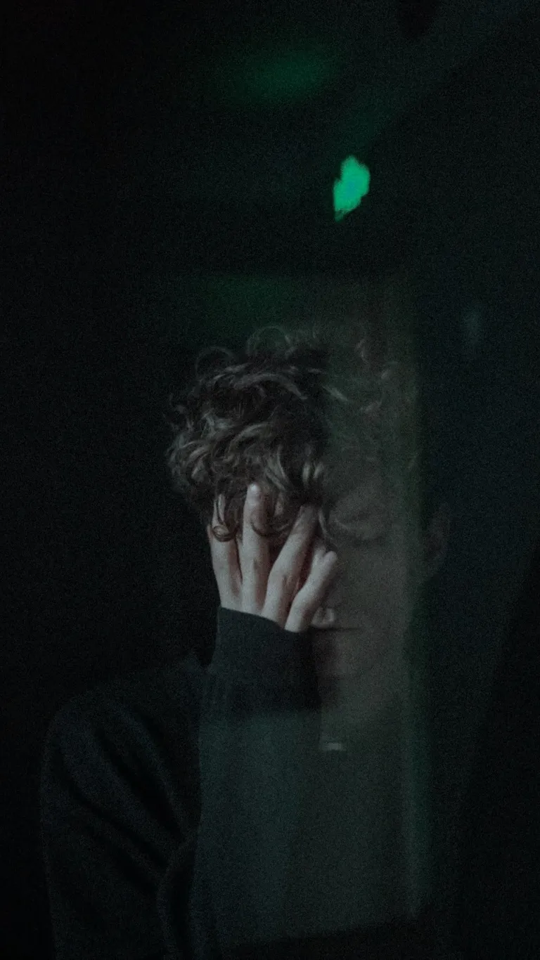 Un joven con su mano sobre su rostro. | Foto: Pexels