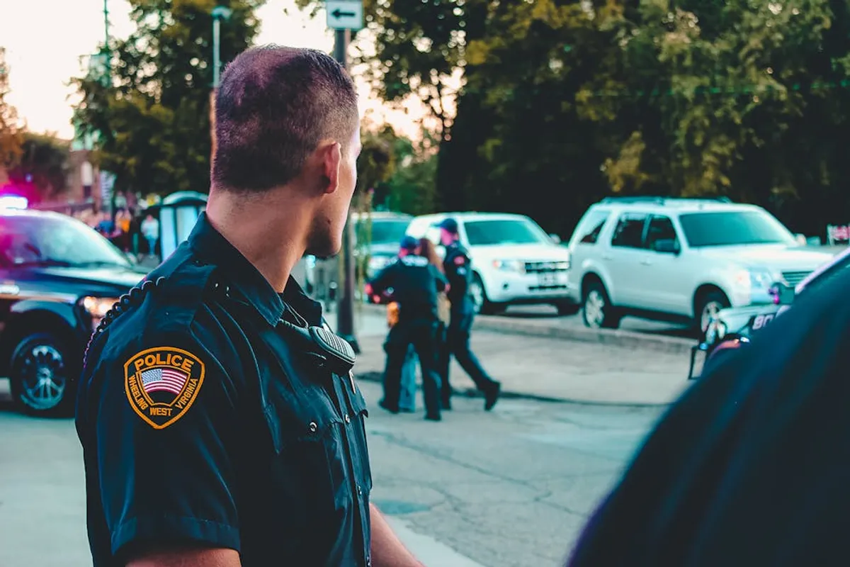 A police officer looking at the cars. | Photo: Pexels