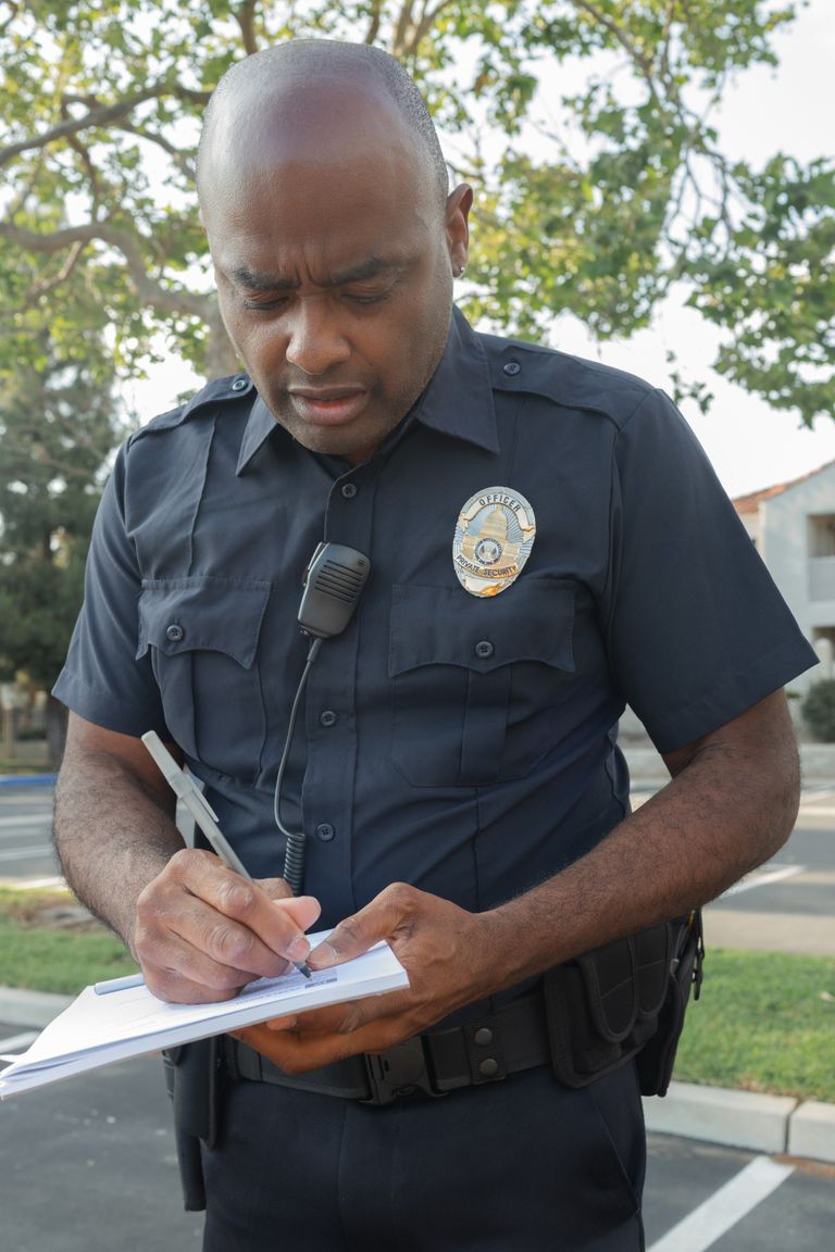 Un oficial de policía escribiendo en una libreta. | Foto: Pexels