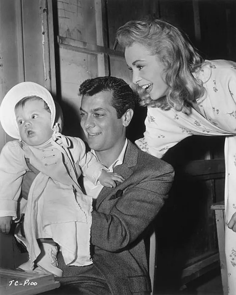 American actors Tony Curtis and Janet Leigh smile at their daughter, Kelly Lee |  Source: Getty Images
