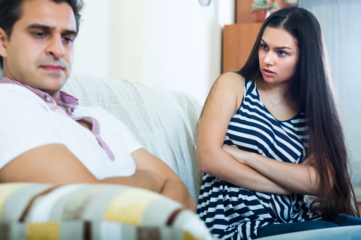 A woman looks upset at her husband. | Photo: Shutterstock