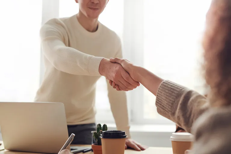 Un hombre y una mujer dándose un apretón de manos. | Foto: Pexels