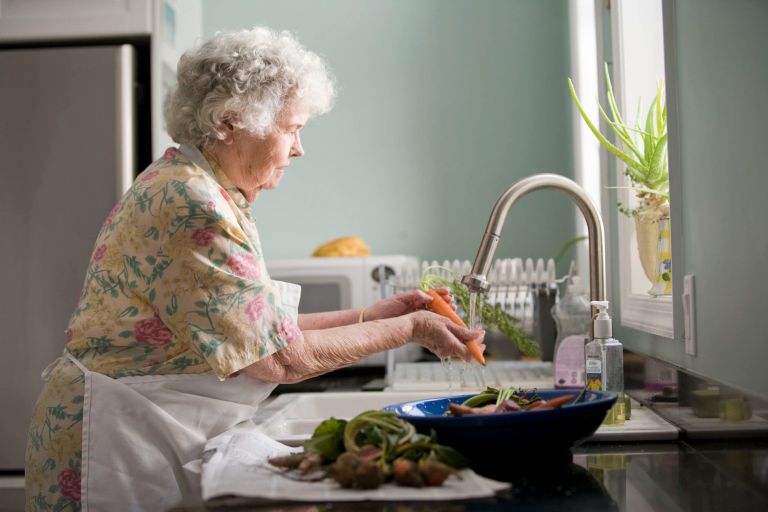 Mujer lavando unas zanahorias. | Foto: Unsplash