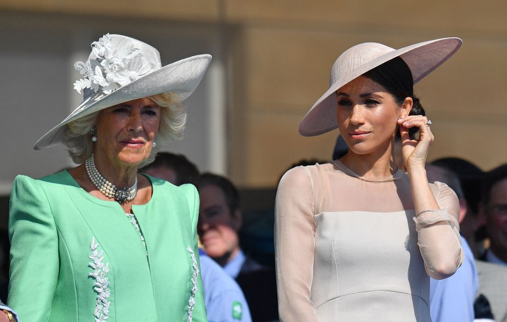Meghan, Duchess of Sussex, and Britain's Camilla,now Queen Consort attend the Prince of Wales's 70th Birthday Garden Party at Buckingham Palace in London on May 22, 2018.