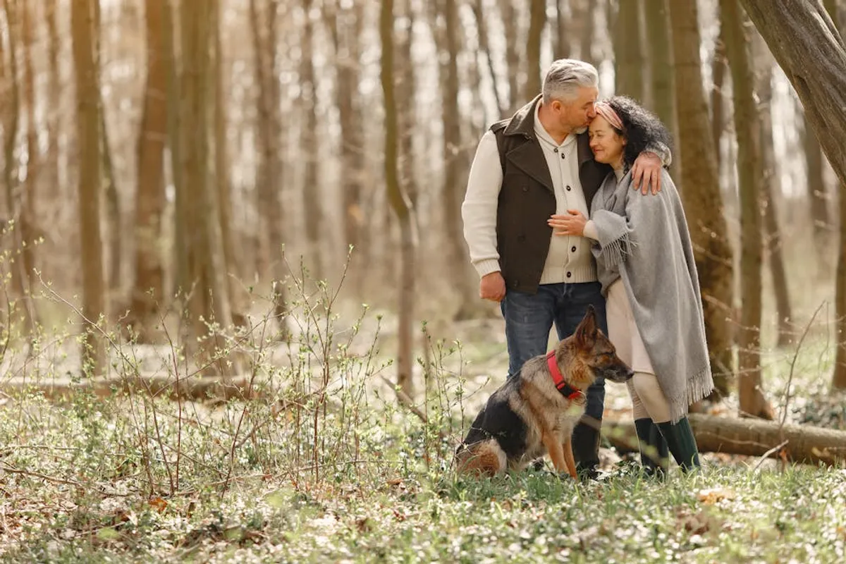 Senior couple with their dog in the forest. | Photo: Pexels