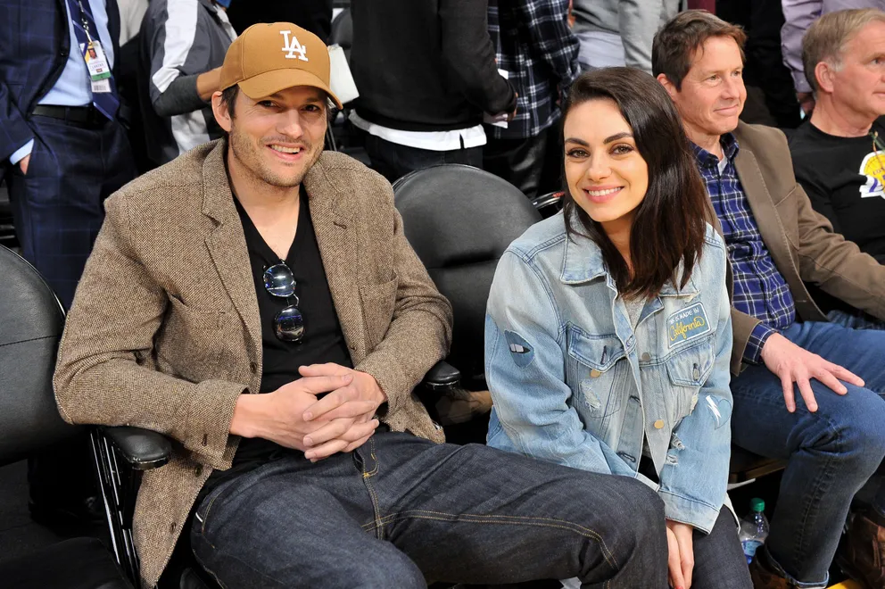 Ashton Kutcher and Mila Kunis smile for the camera at an L.A. Lakers game, January, 2019. | Photo: Getty Images