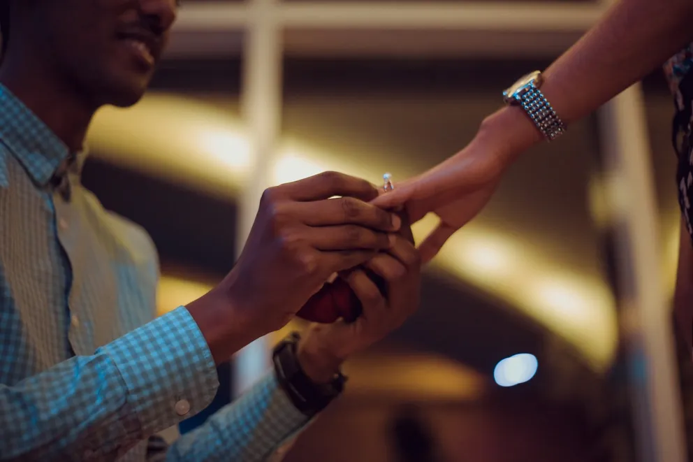 Un hombre colocándole un anillo de compromiso a una mujer. | Foto: Unsplash