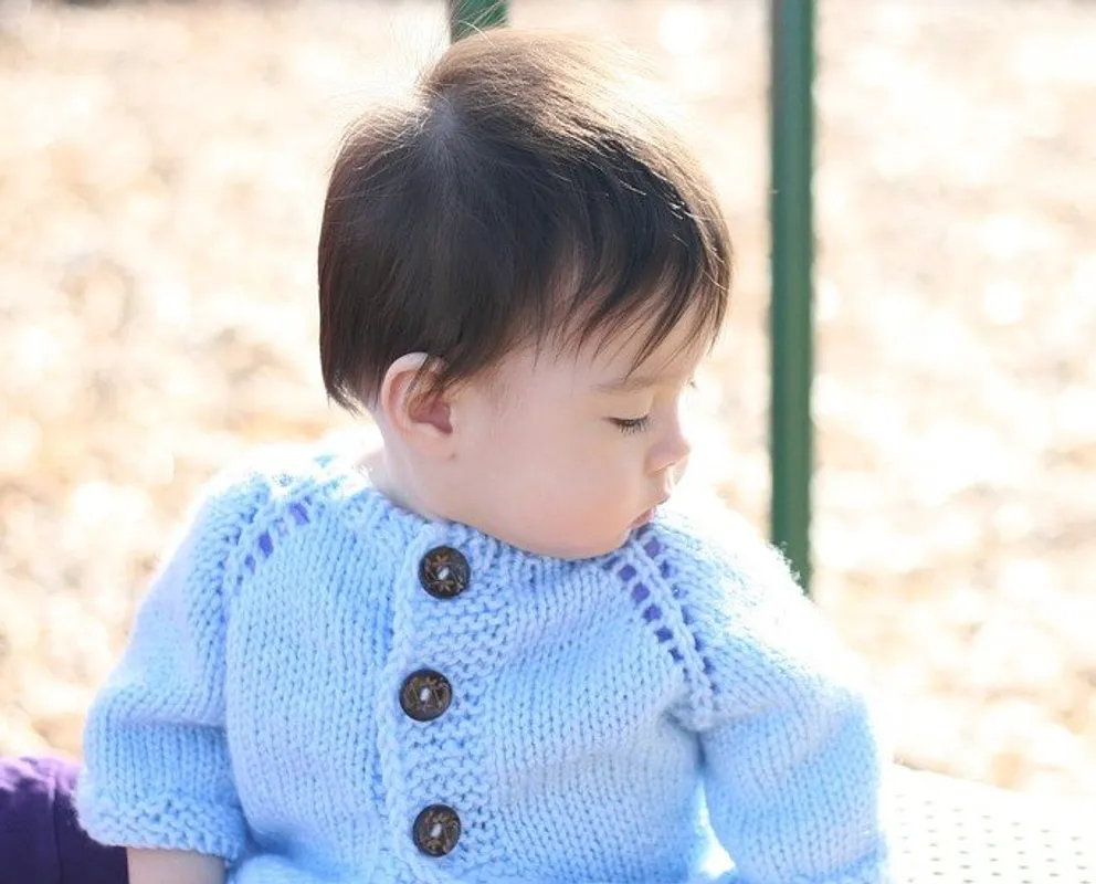 Bebé con suéter azul. | Foto: Pexels