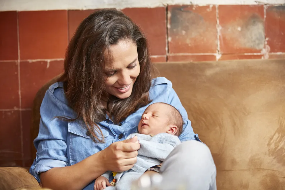 Une mère sourit à son bébé dans un café | Photo : Getty Images