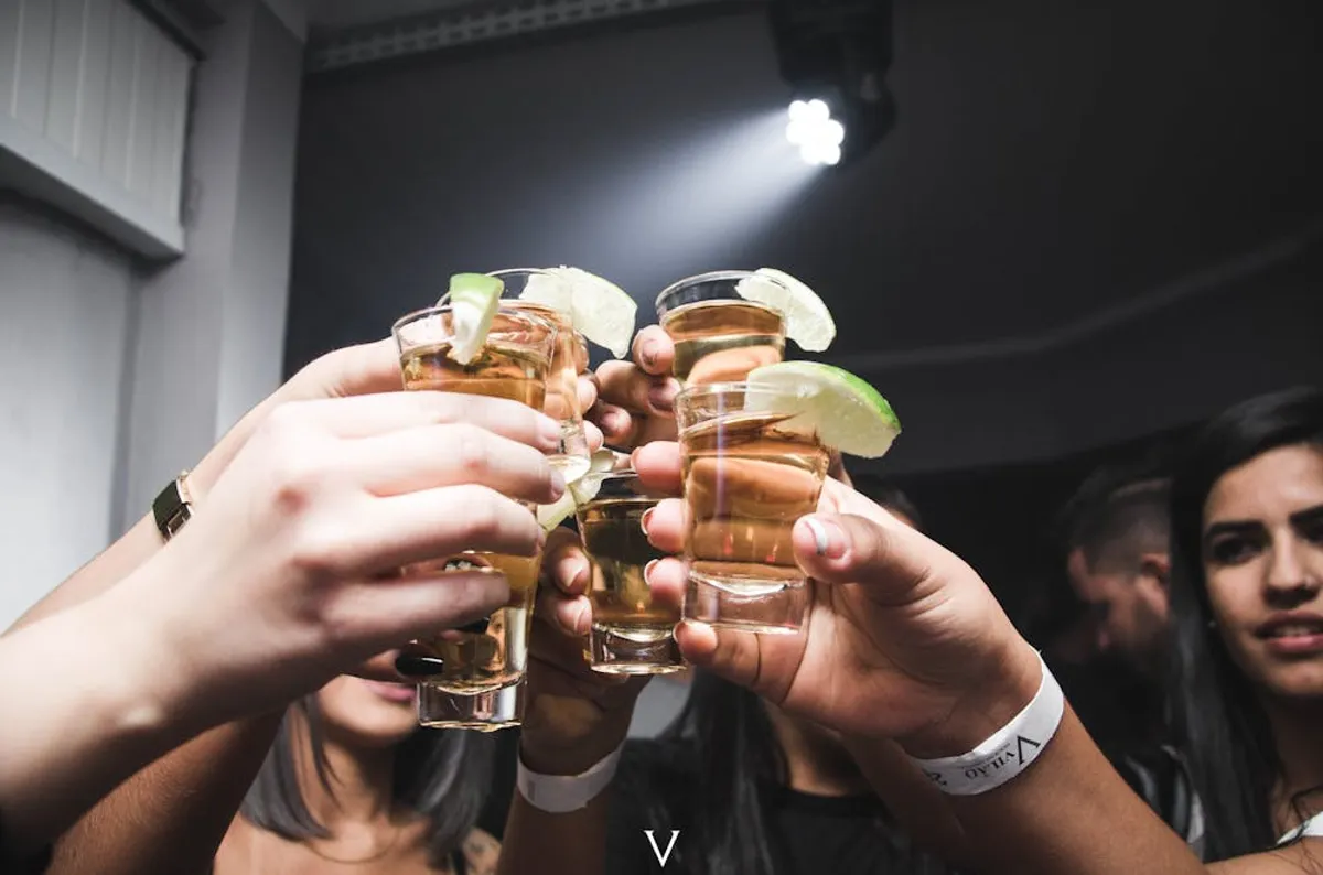 People doing cheers at a bar. | Photo: Pexels