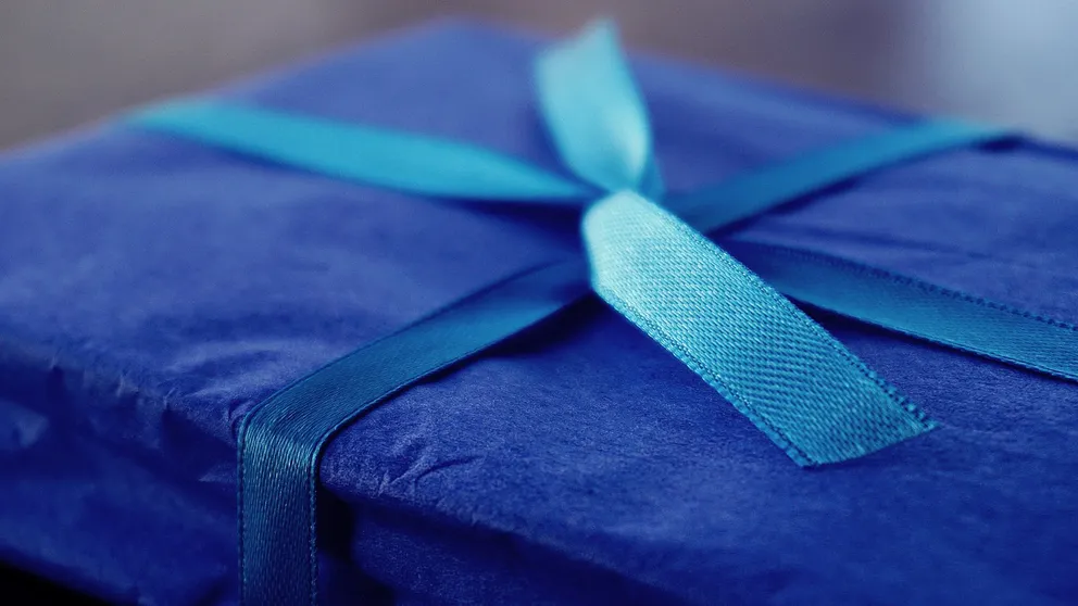 Un obsequio con envoltura azul y una cinta. | Foto: Pexels