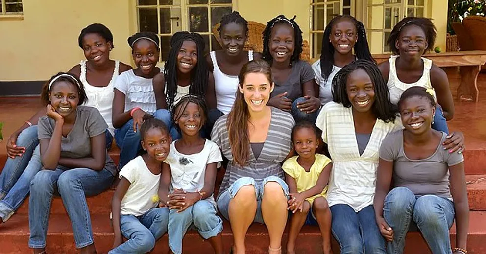 Katie Davis y sus 13 hijas adoptadas. | Foto: Facebook.com/KatieinUganda