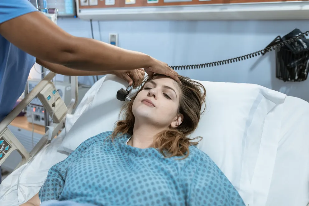 Mujer en una cama de hospital siendo examinada por un médico. | Foto: Pexels